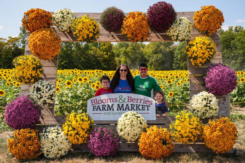 Family visiting Blooms & Berries Farm Market during fall in Loveland, Ohio