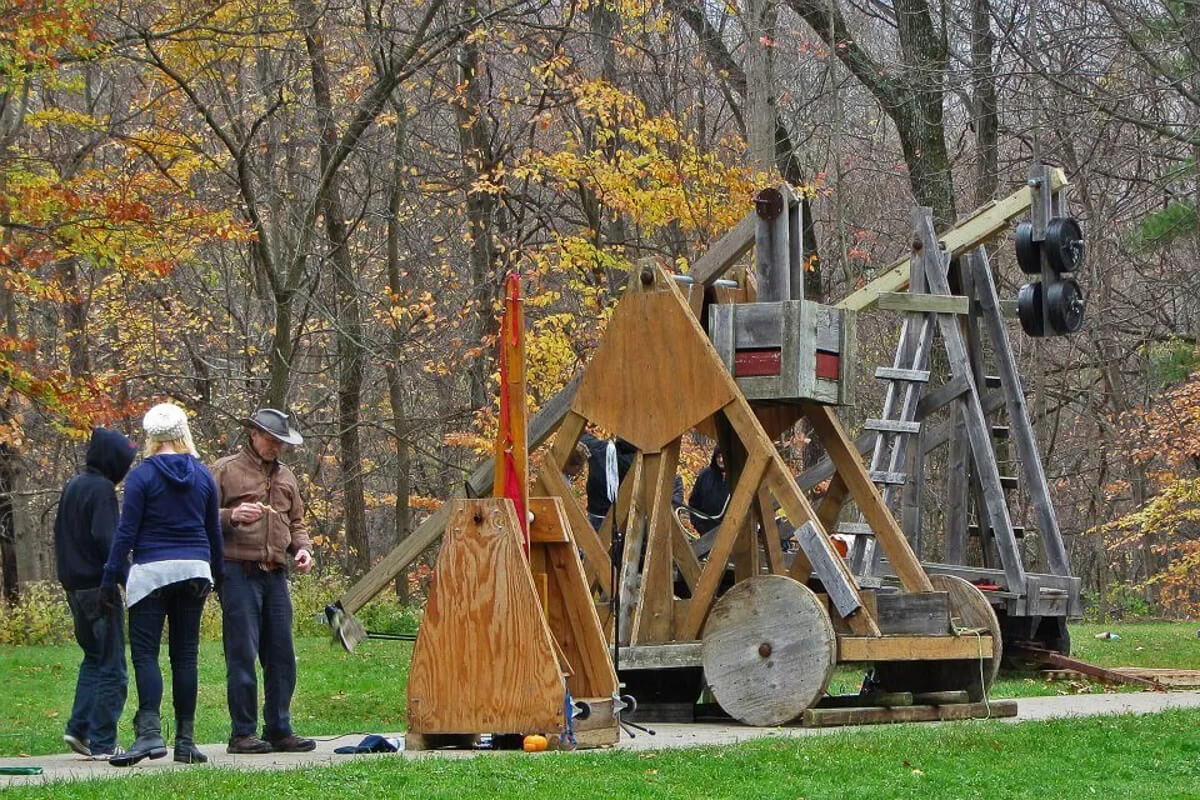 Trebuchet at the Pumpkin Chuck Festival surrounded by fall foliage